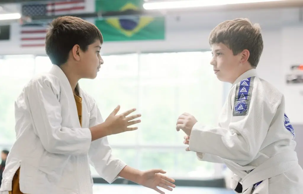 Two kids in white gis practicing BJJ technique at Rising Tide Hi Tech in Hanover MD