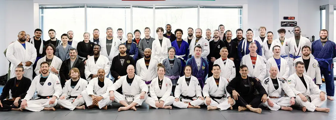Large group photo of adult BJJ students in gis at Rising Tide Hi Tech martial arts in Hanover MD
